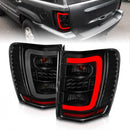 ANZO 1999-2004 Jeep Grand Cherokee LED Tail Lights w/ Light Bar Black Housing Smoke Lens-1