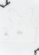 A white Audi crop top for women. Photo is a back view of the top with an embroidered Nogaro Blue Audi 80 RS2 Avant made by Porsche. Fabric composition is polyester, and cotton. The material is stretchy, ribbed, and non-transparent. The style of this shirt is sleeveless, with a scoop neckline.