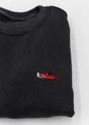 A dark grey BMW/Bimmer E30 M3 crewneck sweater for men. Photo is a close up of the sweater with an embroidered red BMW E30 M3 doing a burnout. Fabric is 100% cotton and high quality and fits to size. The style is long sleeve, crew neck, and embroidery on left chest.