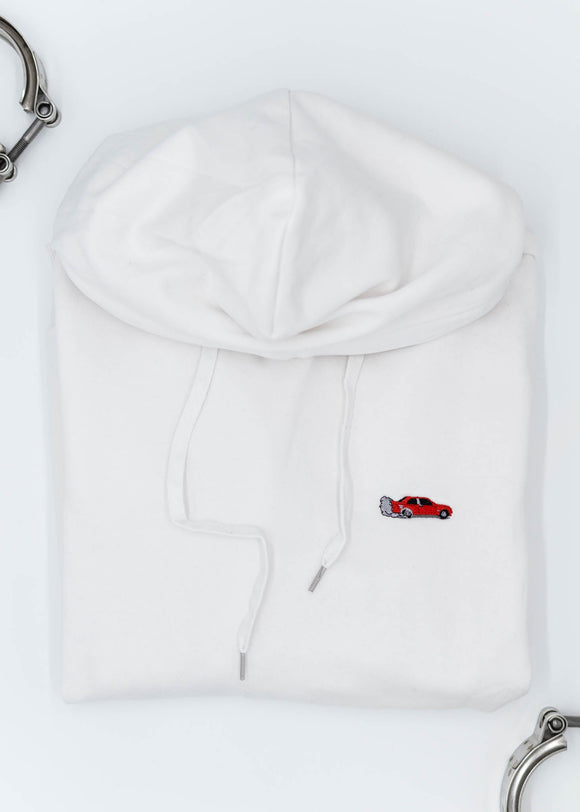 A white BMW/Bimmer unisex hoodie for men and women. Photo is the front of the sweater with an embroidered Red BMW E30 M3 doing a burnout. Fabric composition is cotton, polyester, and rayon. The material is very soft, stretchy, and non-transparent. The style of this hoodie is long sleeve, crewneck with a hood, hooded, with embroidery on the left chest.