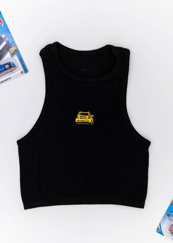 A black Audi crop top for women. Photo is a front view of the top with an embroidered imola yellow Audi B5 RS4. Fabric composition is polyester, and elastine. The material is stretchy, ribbed, and non-transparent. The style of this shirt is sleeveless, with a crewneck neckline.