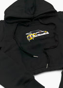 A black Audi cropped hoodie for women. Photo is a front view of the cropped sweater with an embroidered Sport Quattro S1 E2. Fabric composition is cotton, and polyester. The material is soft, stretchy, and non-transparent. The style of this crop hoodie is long sleeve, crewneck with a hood, hooded, with embroidery on the chest.