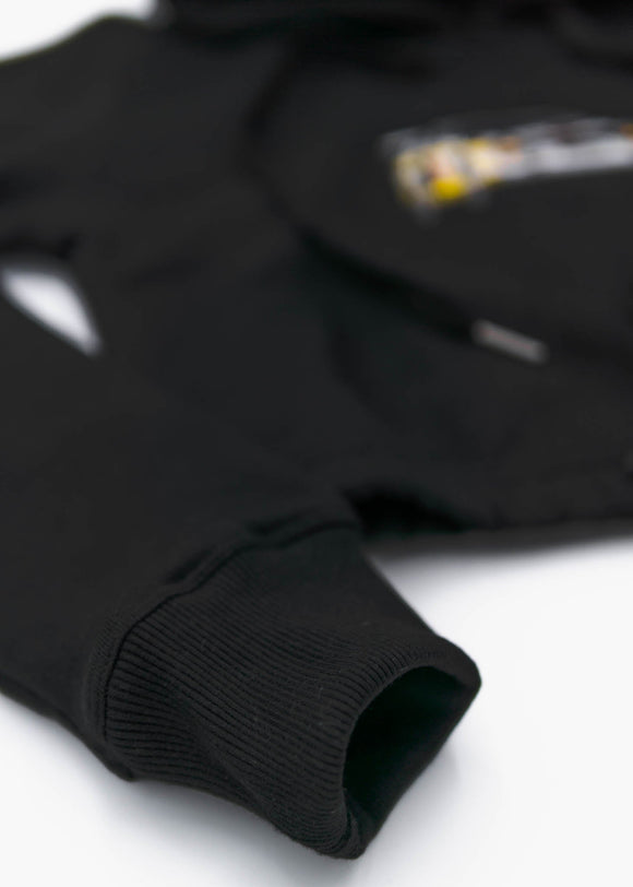 A black Audi cropped hoodie for women. Photo is a front view of the cropped sweater with an embroidered Sport Quattro S1 E2. Fabric composition is cotton, and polyester. The material is soft, stretchy, and non-transparent. The style of this crop hoodie is long sleeve, crewneck with a hood, hooded, with embroidery on the chest.