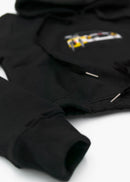 A black Audi cropped hoodie for women. Photo is a front view of the cropped sweater with an embroidered Sport Quattro S1 E2. Fabric composition is cotton, and polyester. The material is soft, stretchy, and non-transparent. The style of this crop hoodie is long sleeve, crewneck with a hood, hooded, with embroidery on the chest.