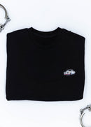 A black BMW crewneck sweater for men. Photo is a close up of the sweater with an embroidered BMW 2002 Turbo. Fabric is composed of high quality 80% cotton, and 20% polyester and fits to size. The style is long sleeve, crew neck, and embroidery on left chest.