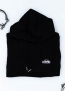 A black BMW cropped hoodie for women. Photo is a close up view of the cropped sweater with an embroidered BMW 2002 Turbo. Fabric composition is 100% cotton. The material is soft, comfortable, breathable, and non-transparent. The style of this crop hoodie is long sleeve, crewneck with a hood, hooded, with embroidery on the chest.