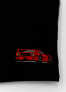 Close up of an embroidered F40 on a women's high quality cropped t-shirt. Photo shows the detailed embroidery of a red F40. Fabric composition of this tee is 100% cotton. The material is very soft, stretchy, and non-transparent. The style of this tshirt is a crewneck, short sleeve, cropped at the waist, with embroidery on the left chest.