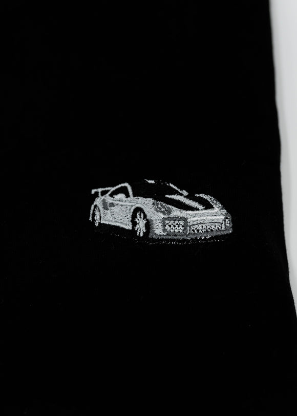 Close up of an embroidered 991.2 GT2 RS on a women's high quality cropped t-shirt. Photo shows the detailed embroidery of a white, silver, and carbon fiber GT2 RS. Fabric composition of this tee is 100% cotton. The material is very soft, stretchy, and non-transparent. The style of this tshirt is a crewneck, short sleeve, cropped at the waist, with embroidery on the left chest.