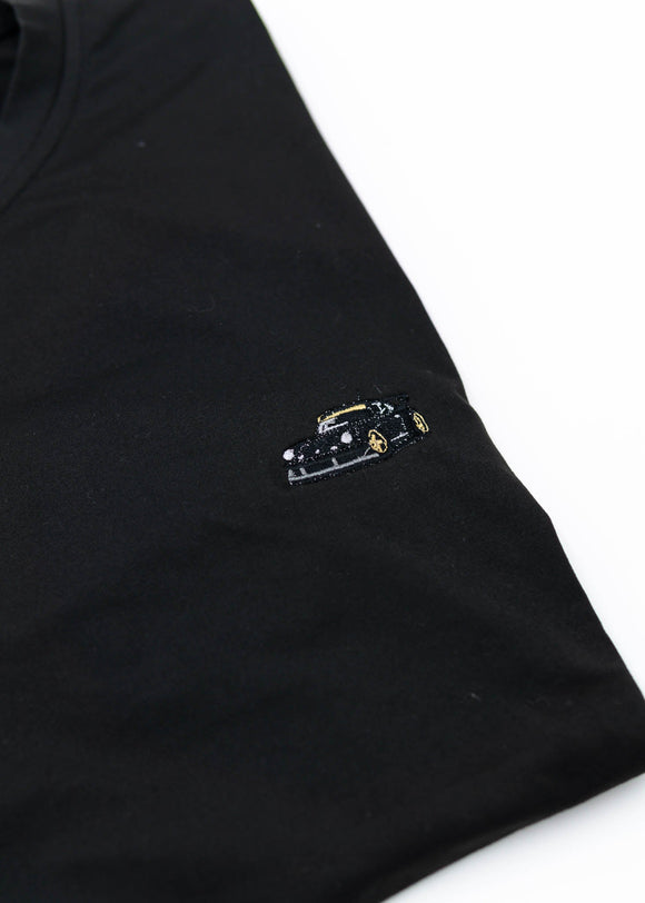 A Black RWB Porsche 930 911 Turbo T-Shirt for men. Photo is a close up view of the shirt with Akira Nakai's RWB Porsche 930 911 Turbo Stella Artois. Fabric composition is a polyester, and cotton mix. The material is very stretchy, soft, comfortable, and non-transparent. The style of this shirt is short sleeve, with a crewneck neckline.