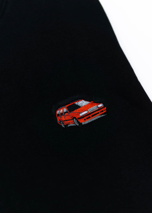 A black Volvo crewneck sweater for men. Photo is a close up of the sweater with an embroidered 850R. Fabric is composed of high quality 80% cotton, and 20% polyester and fits to size. The style is long sleeve, crew neck, and embroidery on left chest.