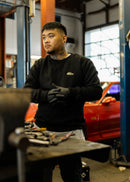 Male model wearing a black Mk1 Golf crewneck sweater.