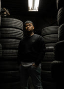 Male model wearing a black W201 190E crewneck sweater.