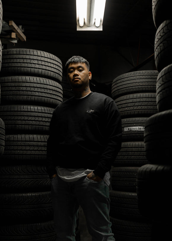 Male model wearing a black W201 190E crewneck sweater.