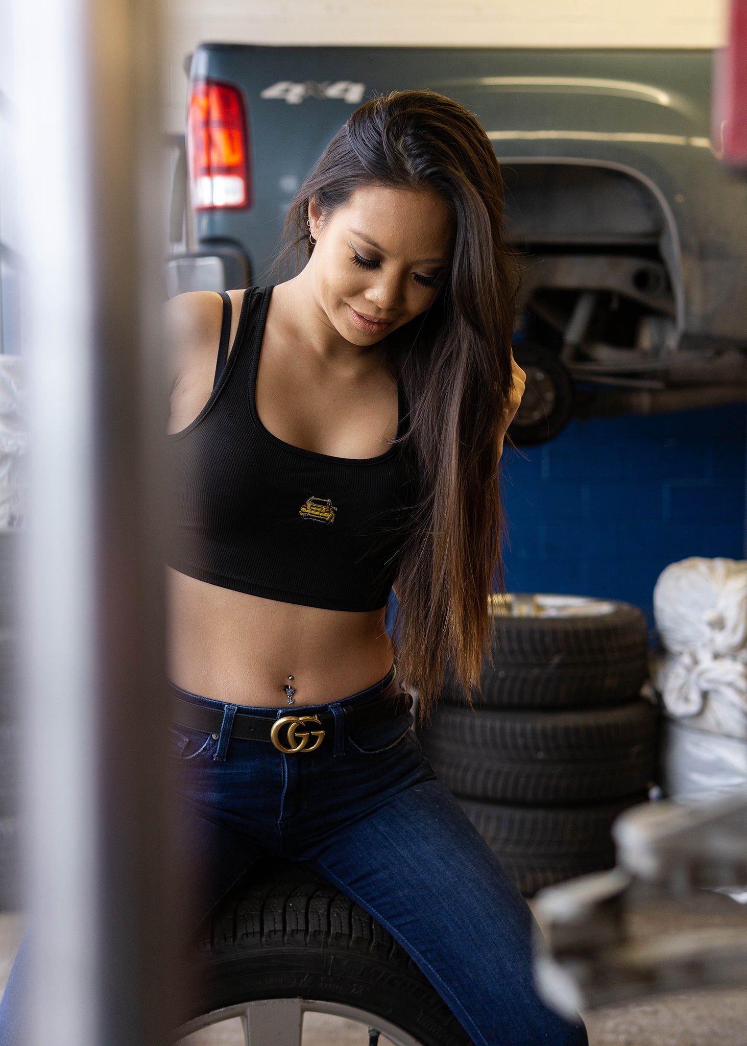 Model wearing black crop top with embroidered B5 RS4 Avant.