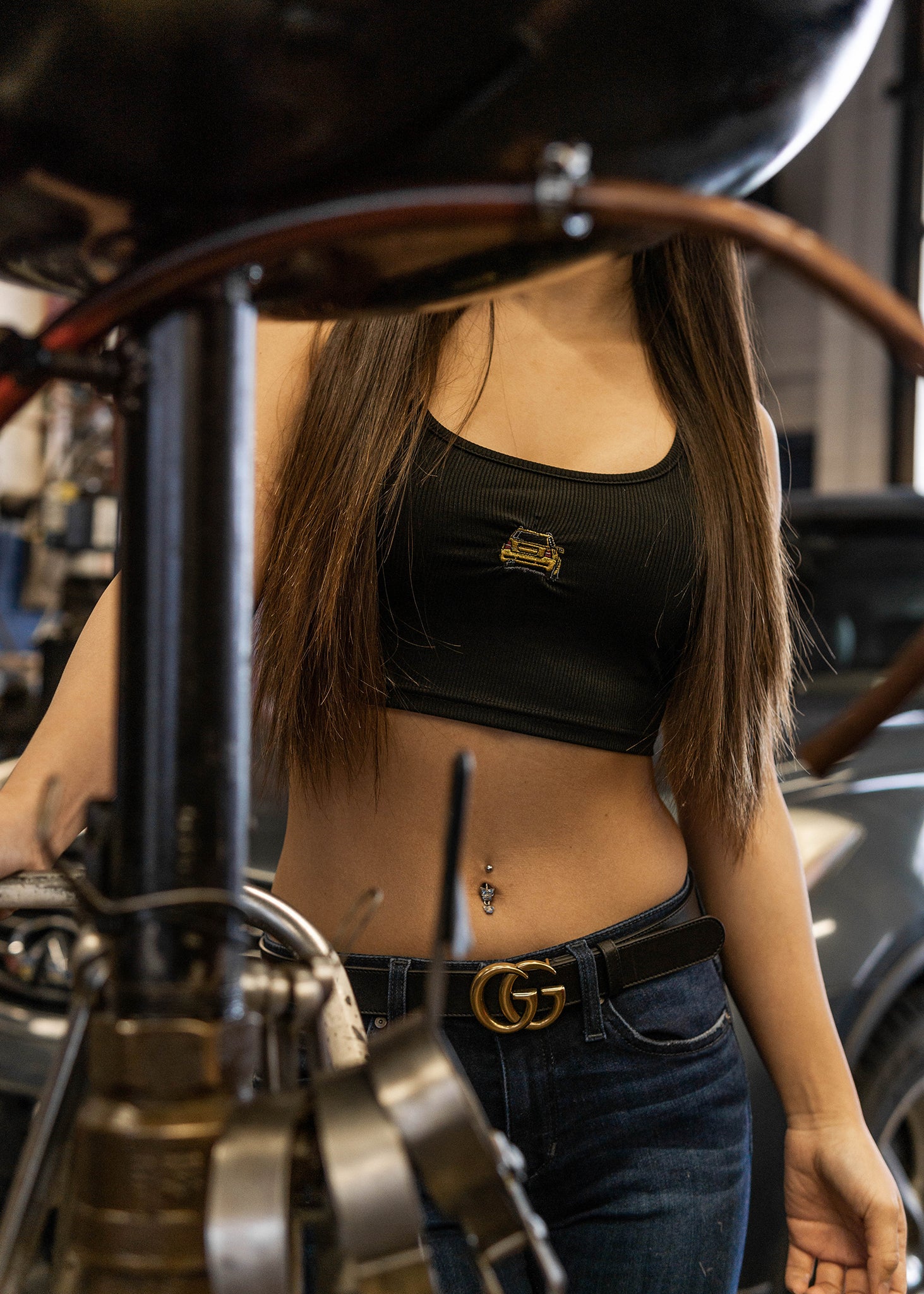 Model wearing black crop top with embroidered B5 RS4 Avant.