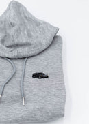 A grey Mercedes-Benz cropped hoodie for women. Photo is a close up view of the cropped sweater with an embroidered W201 190E 2.5-16 Evo II. Fabric composition is 100% cotton. The material is soft, comfortable, breathable, and non-transparent. The style of this crop hoodie is long sleeve, crewneck with a hood, hooded, with embroidery on the chest.