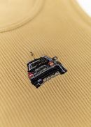 A khaki Audi crop top for women. Photo is a close up view of the top with an embroidered black Audi B5 RS4. Fabric composition is polyester, and elastine. The material is stretchy, ribbed, and non-transparent. The style of this shirt is sleeveless, with a crewneck neckline.