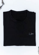 A black Mercedes-Benz t-shirt for men. Photo is a close up of the shirt with an embroidered black W201 190E Evo II. Fabric composition is a polyester. The material is very soft, stretchy, non-transparent. The style of this shirt is short sleeve, with a crewneck neckline.