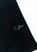 A black Mercedes-Benz t-shirt for men. Photo is a close up of the shirt with an embroidered black W201 190E Evo II. Fabric composition is a polyester. The material is very soft, stretchy, non-transparent. The style of this shirt is short sleeve, with a crewneck neckline.
