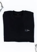 A black Mercedes-Benz crewneck sweater for men. Photo is a close up of the sweater with an embroidered Mercedes-Benz W201 190E 2.5-16 Evo II. Fabric is composed of high quality 80% cotton, and 20% polyester and fits to size. The style is long sleeve, crew neck, and embroidery on left chest.