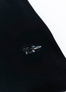 A black Mercedes-Benz crewneck sweater for men. Photo is a close up of the sweater with an embroidered Mercedes-Benz W201 190E 2.5-16 Evo II. Fabric is composed of high quality 80% cotton, and 20% polyester and fits to size. The style is long sleeve, crew neck, and embroidery on left chest.
