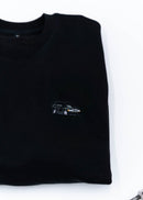 A black Mercedes-Benz crewneck sweater for men. Photo is a close up of the sweater with an embroidered Mercedes-Benz W201 190E 2.5-16 Evo II. Fabric is composed of high quality 80% cotton, and 20% polyester and fits to size. The style is long sleeve, crew neck, and embroidery on left chest.