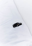 A white Mercedes-Benz t-shirt for men. Photo is a close up view of the shirt with an embroidered black W201 190E 2.5-16 Evo II. Fabric composition is a polyester, and cotton mix. The material is very soft, stretchy, non-transparent. The style of this shirt is short sleeve, with a crewneck neckline.
