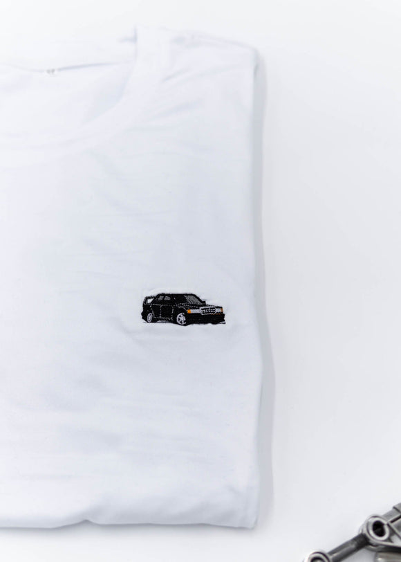 A white Mercedes-Benz t-shirt for men. Photo is a close up view of the shirt with an embroidered black W201 190E 2.5-16 Evo II. Fabric composition is a polyester, and cotton mix. The material is very soft, stretchy, non-transparent. The style of this shirt is short sleeve, with a crewneck neckline.