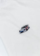 A black Audi t-shirt for men. Photo is a close up of the shirt with an embroidered Martini R13 Porsche 911 Carrera RSR 2.1 Turbo. Fabric composition is a polyester, and cotton mix. The material is very soft, stretchy, non-transparent. The style of this shirt is short sleeve, with a crewneck neckline.