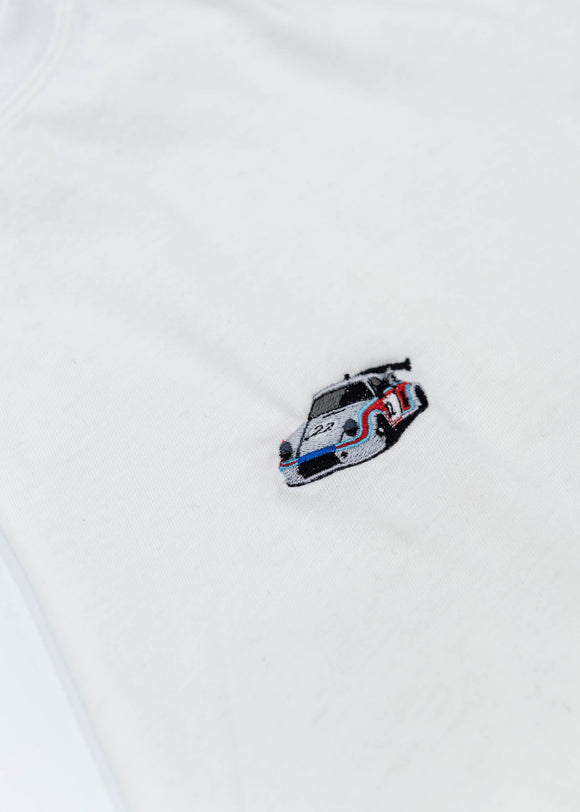 A black Audi t-shirt for men. Photo is a close up of the shirt with an embroidered Martini R13 Porsche 911 Carrera RSR 2.1 Turbo. Fabric composition is a polyester, and cotton mix. The material is very soft, stretchy, non-transparent. The style of this shirt is short sleeve, with a crewneck neckline.