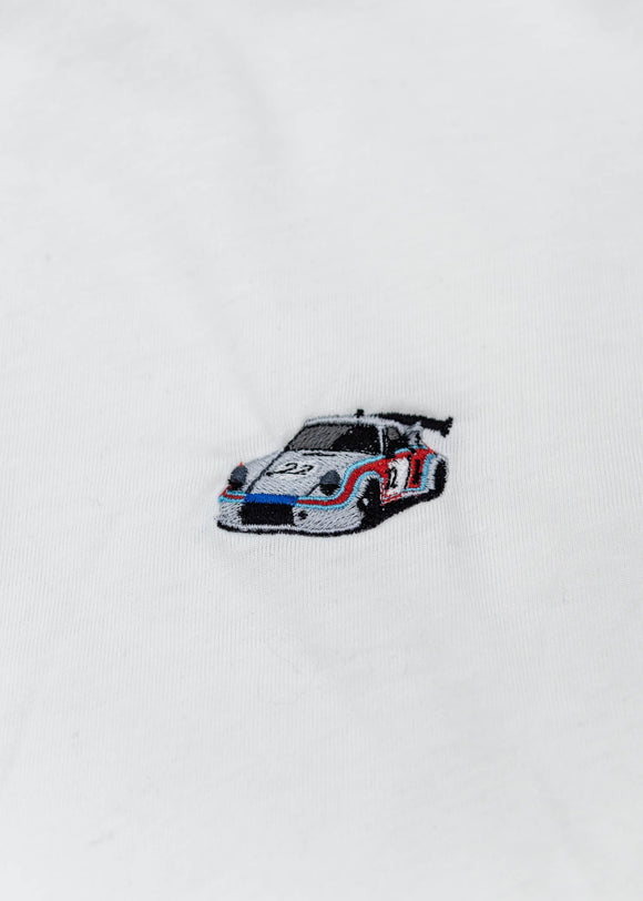 A black Audi t-shirt for men. Photo is a close up of the shirt with an embroidered Martini R13 Porsche 911 Carrera RSR 2.1 Turbo. Fabric composition is a polyester, and cotton mix. The material is very soft, stretchy, non-transparent. The style of this shirt is short sleeve, with a crewneck neckline.
