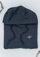 A dark grey Porsche racing unisex hoodie for men and women. Photo is a close up of the sweater with an embroidered Martini R13 Porsche 911 Carrera RSR 2.1 Turbo. Fabric composition is cotton, polyester, and rayon. The material is very soft, stretchy, and non-transparent. The style of this hoodie is long sleeve, crewneck with a hood, hooded, with embroidery on the left chest.