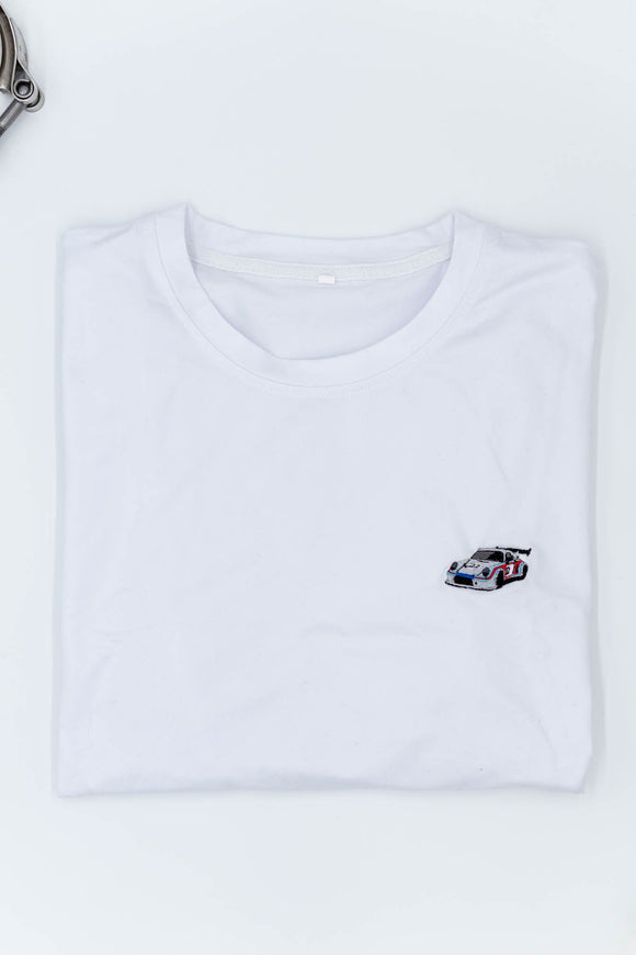 A white Porsche T-Shirt for men. Photo is the front of the shirt with an embroidered Martini R13 Porsche 911 Carrera RSR 2.1 Turbo. Fabric composition is 100% polyester. The material is very stretchy, soft, comfortable, breathable, and non-transparent. The style of this shirt is short sleeve, with a crewneck neckline.