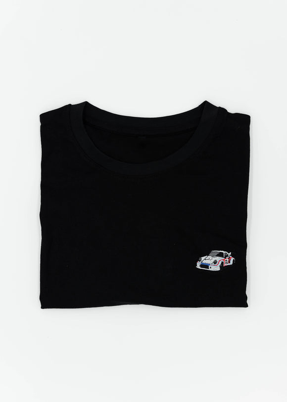 Close up of an embroidered R13 1974 911 RSR Turbo on a women's high quality cropped t-shirt. Photo shows the detailed embroidery of a R13 1974 911 RSR Turbo. Fabric composition of this tee is 100% cotton. The material is very soft, stretchy, and non-transparent. The style of this tshirt is a crewneck, short sleeve, cropped at the waist, with embroidery on the left chest.