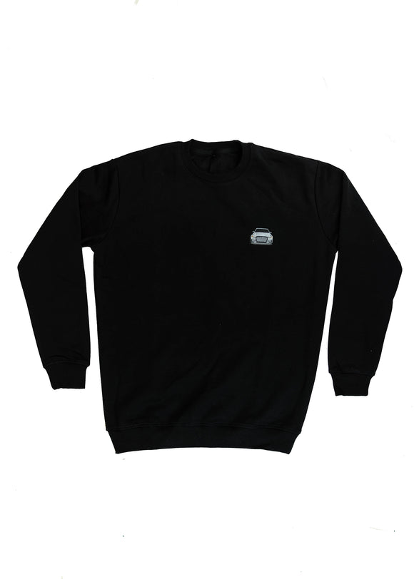A black men's high quality crewneck sweater. Full size front view of the black sweater with a nardo grey embroidered 8V RS3. Fabric composition is a mix of cotton and polyester. The material is very soft, stretchy, and non-transparent. The style of this sweater is a crewneck, long sleeve, elastic bottom, with embroidery on the left chest.