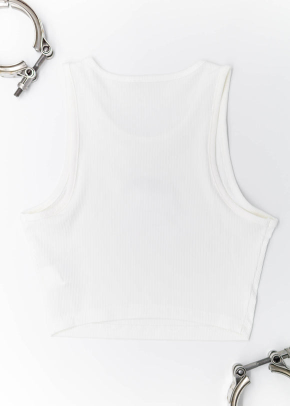 A white ribbed stretchy crop top with embroidery of a small RWB 930 911 Turbo - Akira Nakai "Stella Artois" on the front. Full size back view of the white shirt with an embroidered RWB 930 911 Turbo. Fabric composition of this top is 95% polyester, and 5% elastane. The material is very stretchy, and form fitting. The style of this shirt is scoop neck, sleeveless, cropped at the waist, with embroidery in the middle.