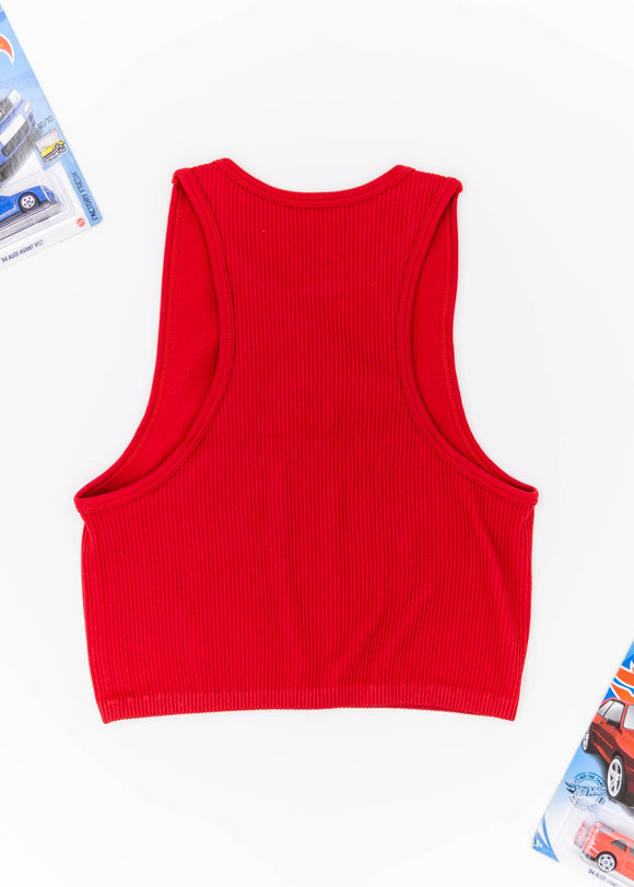 A red Audi crop top for women. Photo is a blank canvas back view of the top with an embroidered black Audi B5 RS4. Fabric composition is polyester, and elastine. The material is stretchy, ribbed, and non-transparent. The style of this shirt is sleeveless, with a crewneck neckline.