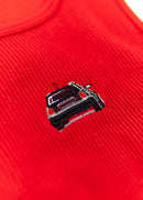 A red Audi crop top for women. Photo is a close up view of the top with an embroidered black Audi B5 RS4. Fabric composition is polyester, and elastine. The material is stretchy, ribbed, and non-transparent. The style of this shirt is sleeveless, with a crewneck neckline.