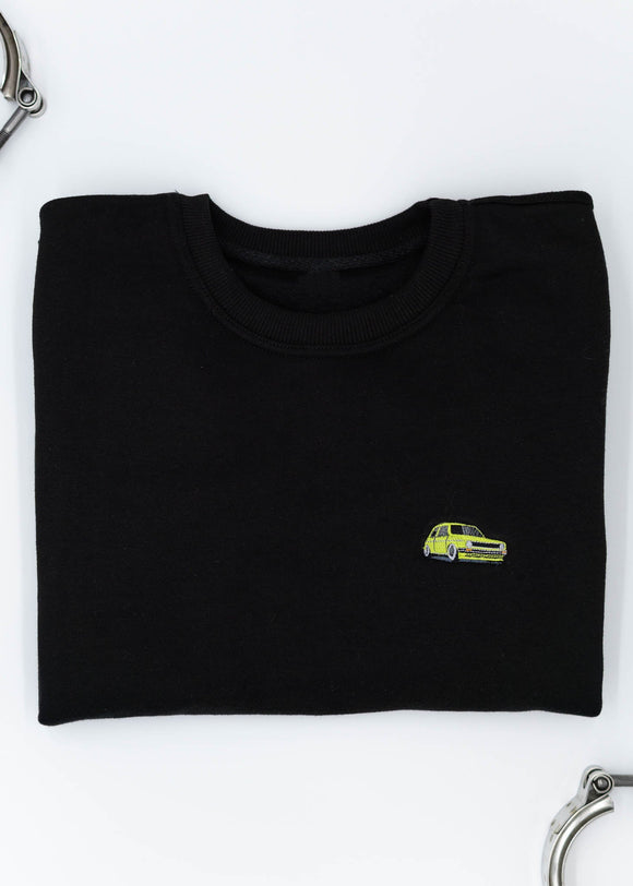 A black VW Volkswagen crewneck sweater for men. Photo is the front of the sweater with an embroidered modified green VW Mk1 Golf. Fabric is 100% cotton and high quality and fits to size. The style is long sleeve, crew neck, and embroidery on left chest.