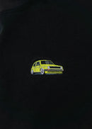 A black cropped t-shirt for VW women and plus size women. Close up of a 100% cotton crop tee with an embroidered VW Mk1 Golf. The material is stretchy, and non-transparent with a crewneck neckline and short sleeves.