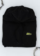 A black VW Volkswagen unisex hoodie for men and women. Photo is a front view of the sweater with an embroidered modified green Mk1 Golf. Fabric composition is cotton, polyester, and rayon. The material is very soft, stretchy, and non-transparent. The style of this hoodie is long sleeve, crewneck with a hood, hooded, with embroidery on the left chest.
