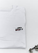 A white BMW 2002 Turbo t-shirt for men. Photo is a close up of the shirt with an embroidered 2002 Turbo. Fabric composition is a polyester and cotton mix. The material is very soft, stretchy, non-transparent. The style of this shirt is short sleeve, with a crewneck neckline.