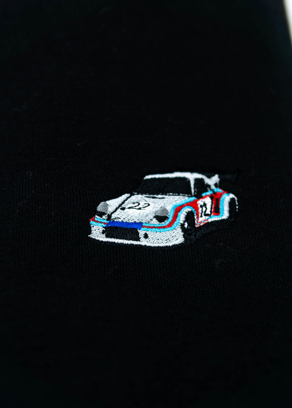 A black 911 RSR 2.1 Turbo crewneck sweater for men. Photo is a close up of the sweater with an embroidered 911 RSR 2.1 Turbo. Fabric is a cotton and polyester mix and high quality and fits to size. The style is long sleeve, crew neck, and embroidery on left chest.