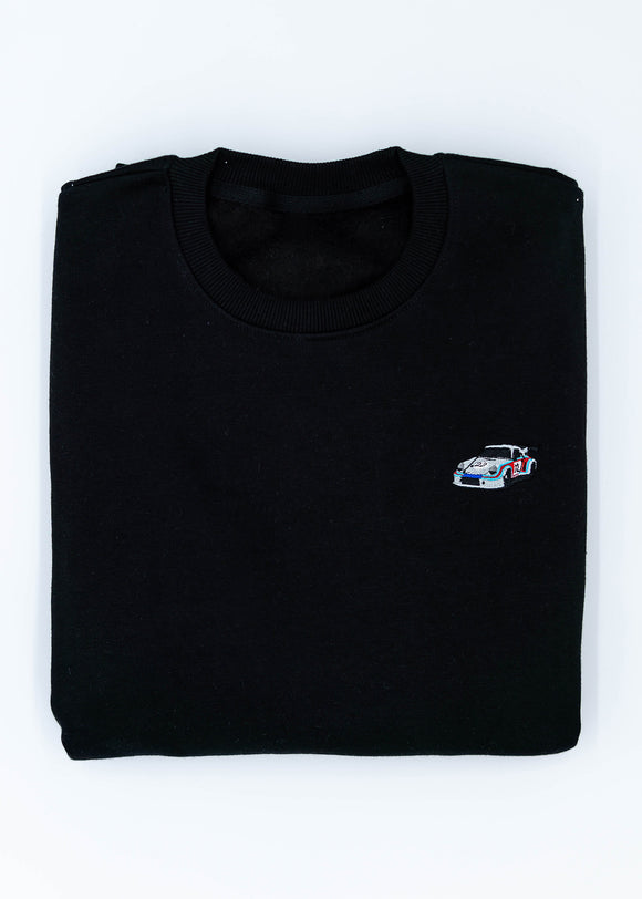 A black 911 RSR 2.1 Turbo crewneck sweater for men. Photo is the front of the sweater with an embroidered 911 RSR 2.1 Turbo. Fabric is a cotton and polyester mix and high quality and fits to size. The style is long sleeve, crew neck, and embroidery on left chest.