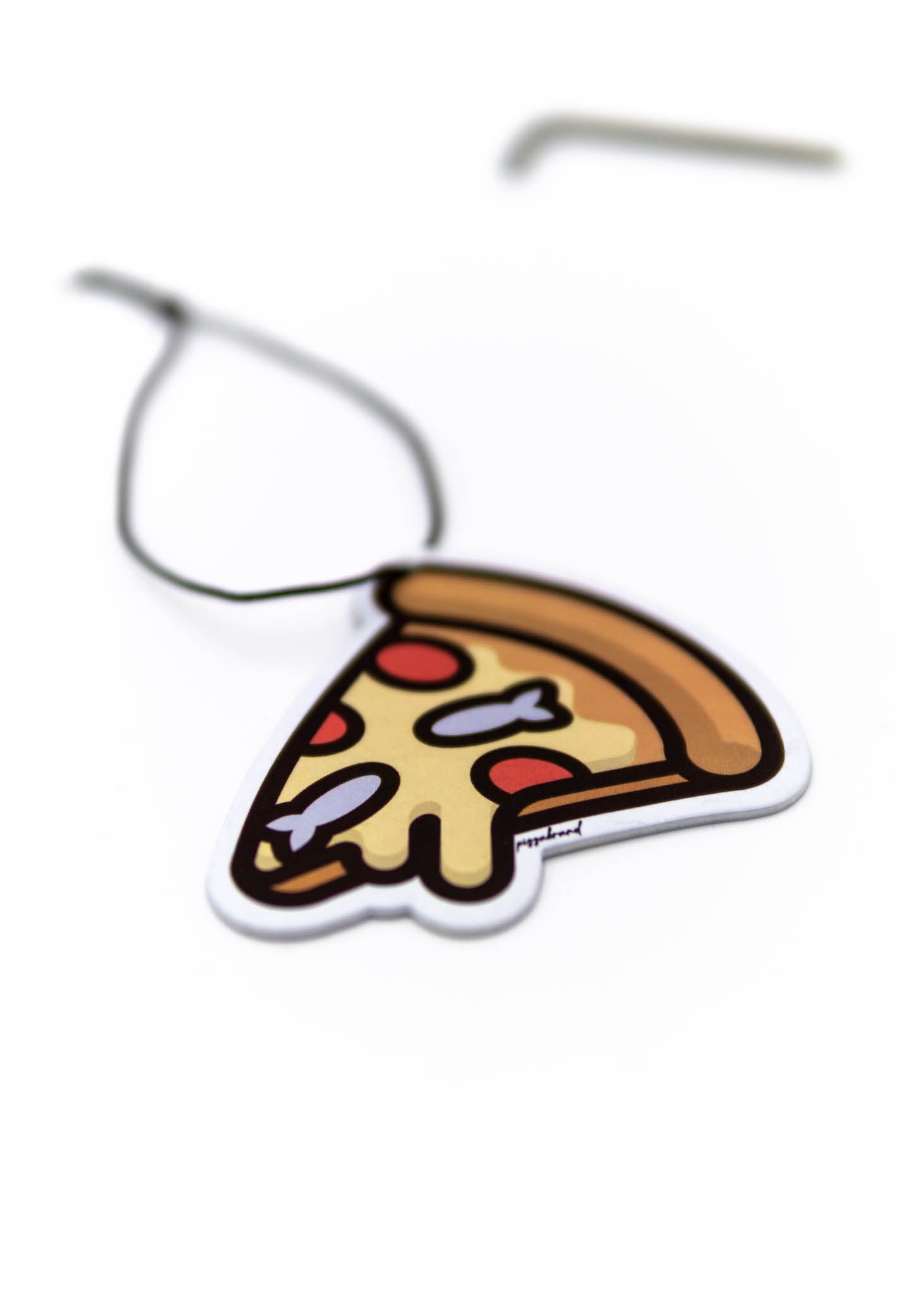 A pizzabrand anchovy and pepperonin air freshener. Photo is a close up of the car air freshener with string.