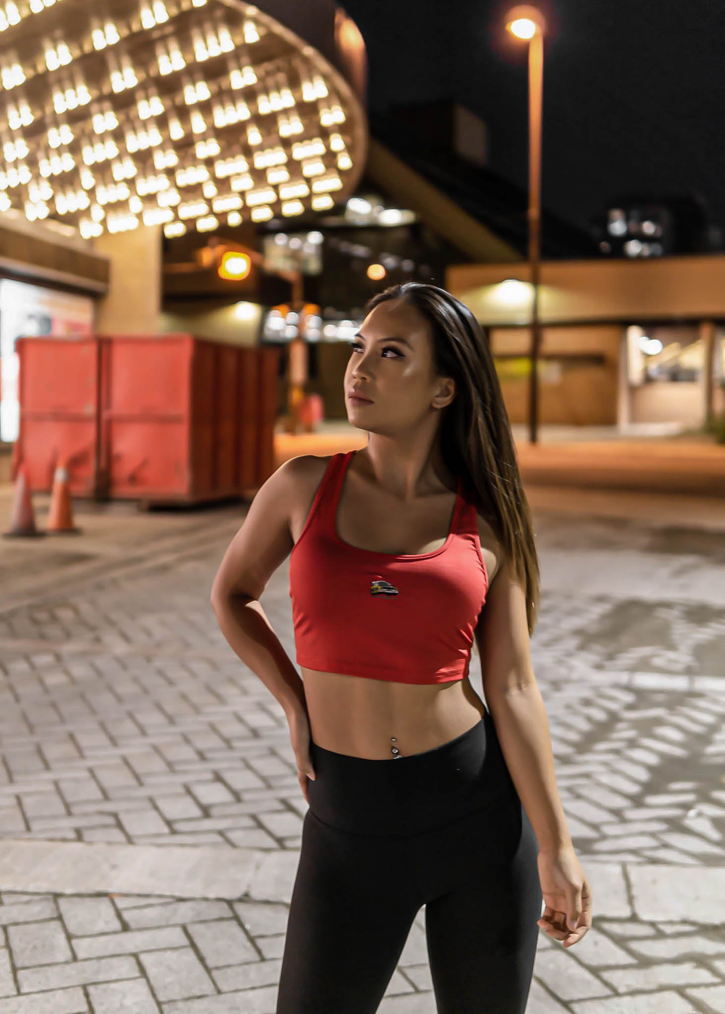 A model posing with pizzabrand Audi Sport Quattro S1 E2 crop top in red.