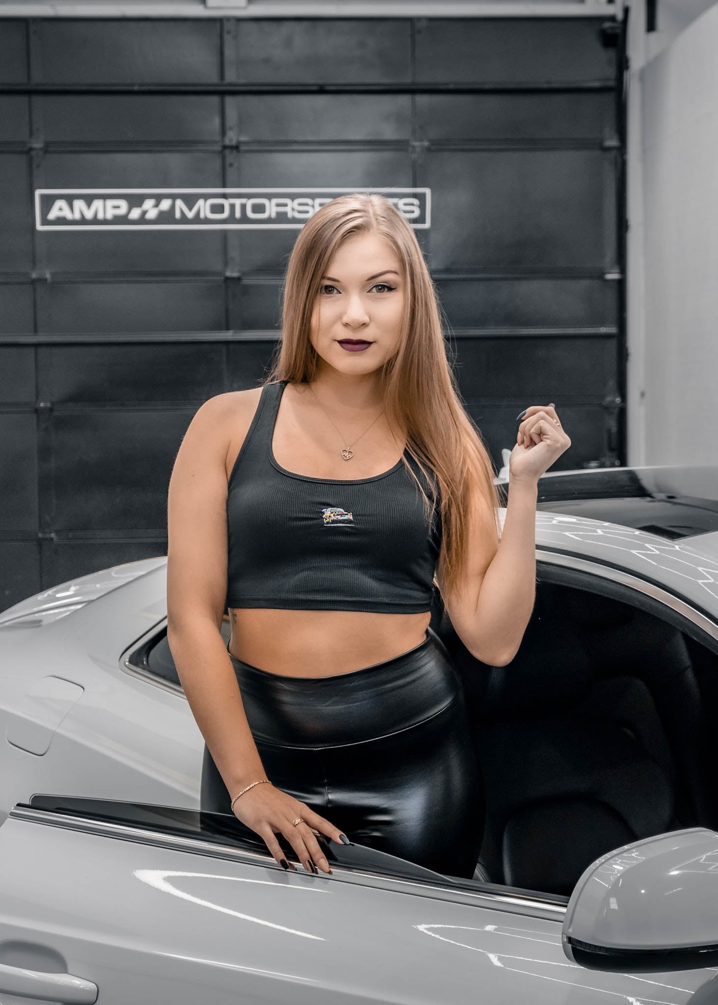 A model posing with pizzabrand Audi Sport Quattro S1 E2 crop top in black.