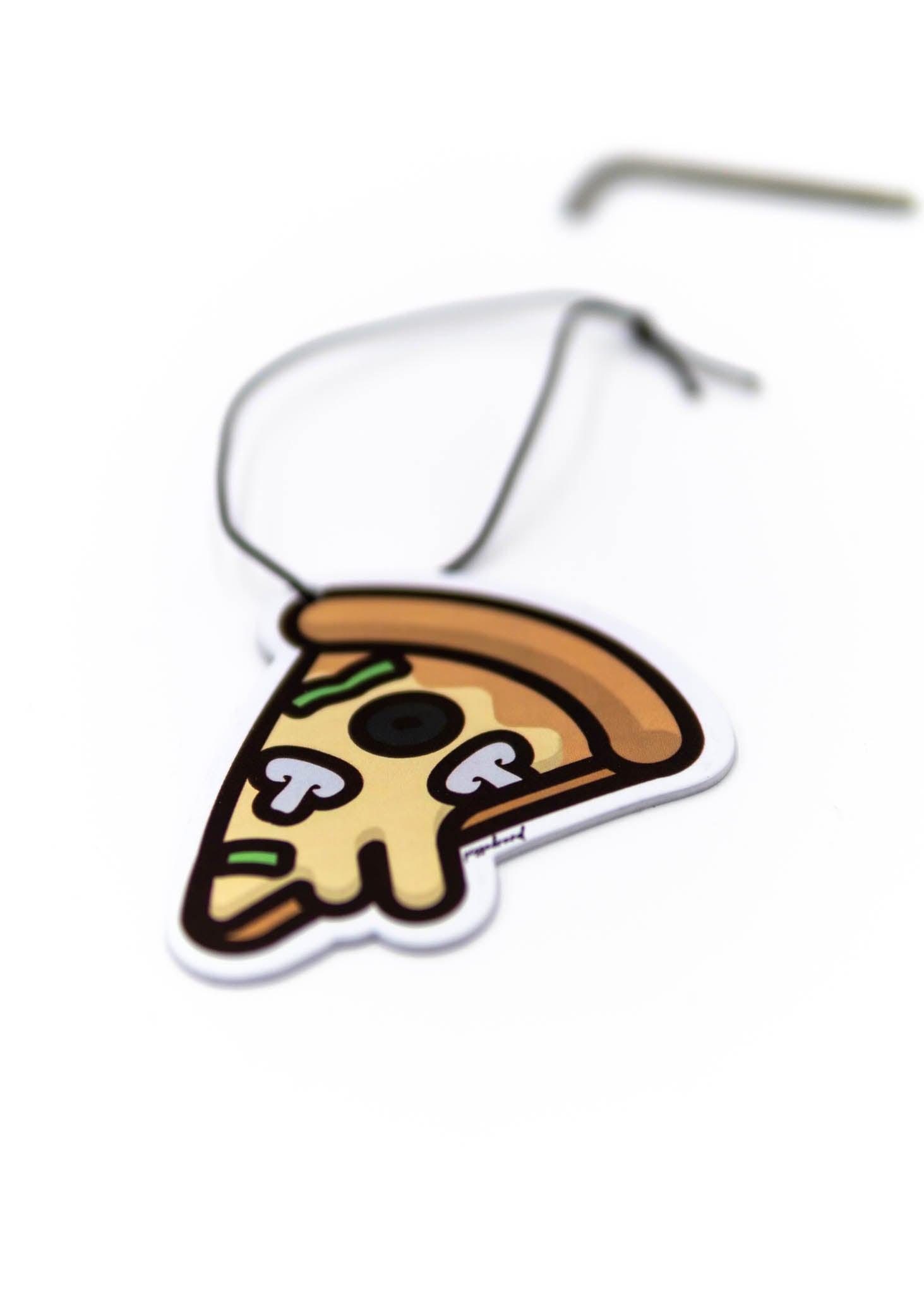 A pizzabrand black olives, mushroom, and green peppers pizza air freshener. Photo is a close up of the car air freshener with string.
