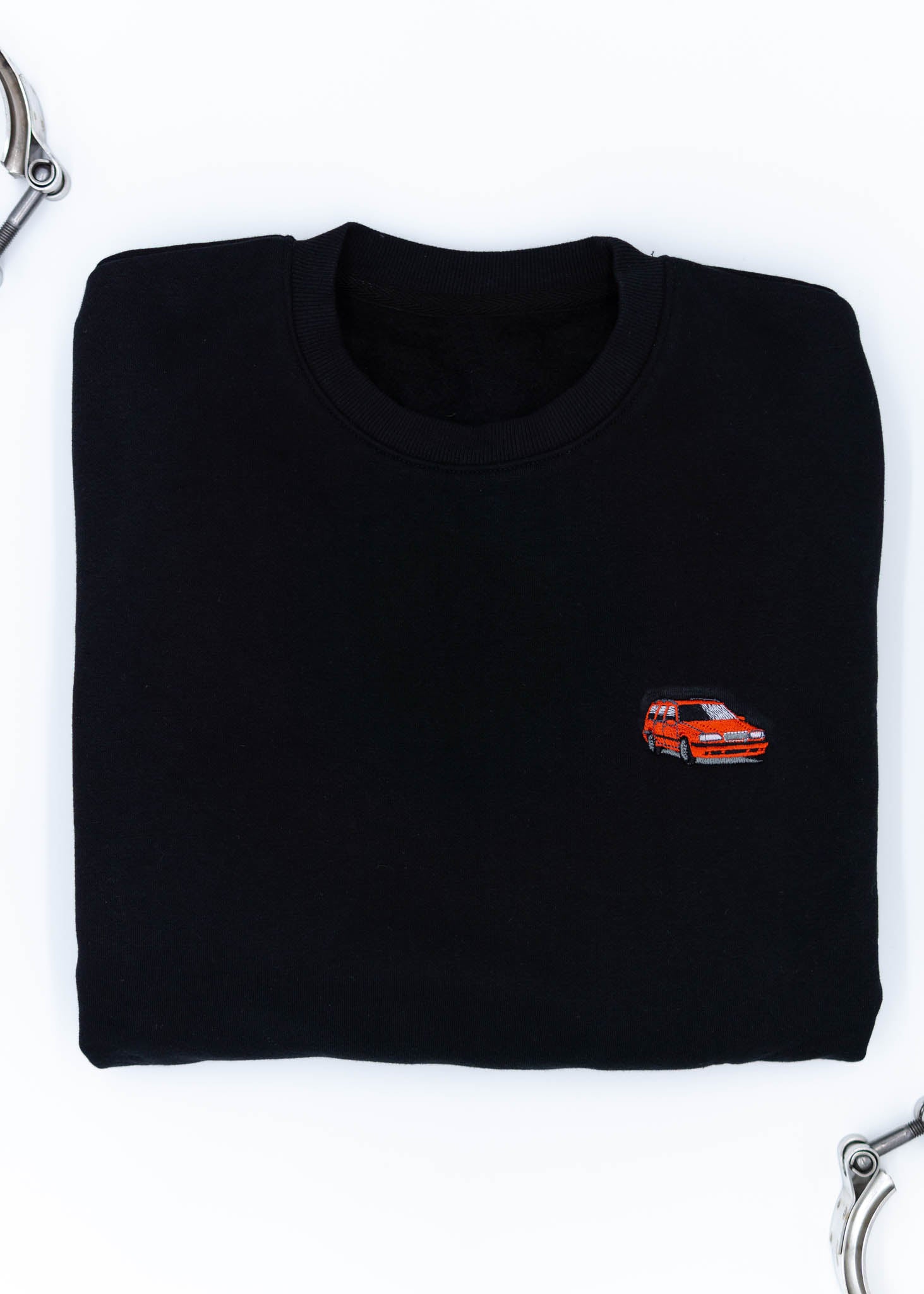 A black Volvo crewneck sweater for men. Photo is a close up of the sweater with an embroidered 850R. Fabric is composed of high quality 80% cotton, and 20% polyester and fits to size. The style is long sleeve, crew neck, and embroidery on left chest.