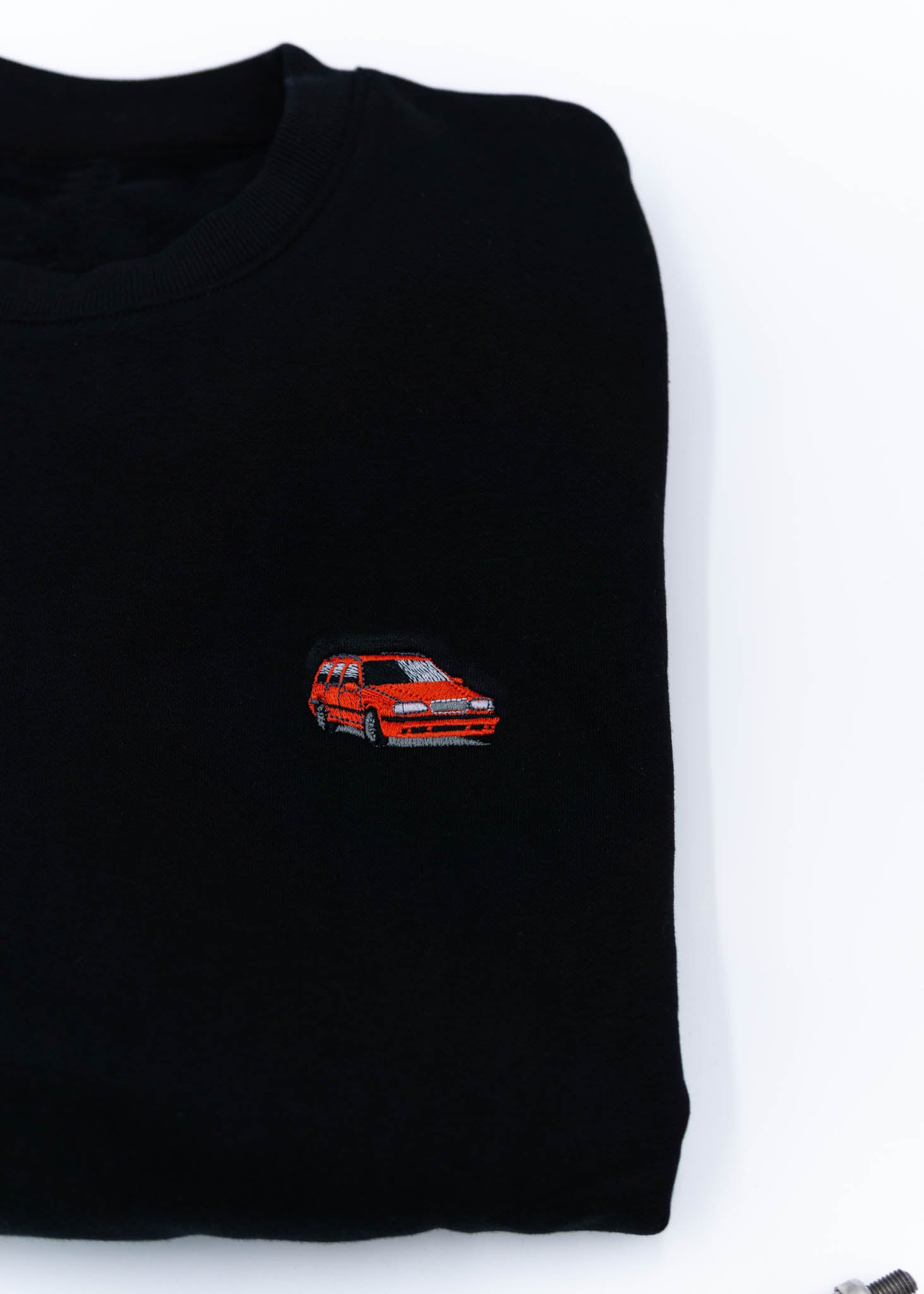 A black Volvo crewneck sweater for men. Photo is a close up of the sweater with an embroidered 850R. Fabric is composed of high quality 80% cotton, and 20% polyester and fits to size. The style is long sleeve, crew neck, and embroidery on left chest.